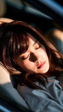 A tired woman resting in a car interior creates a realistic travel lifestyle visual emphasizing fatigue, road trip moments, and vehicle comfort.