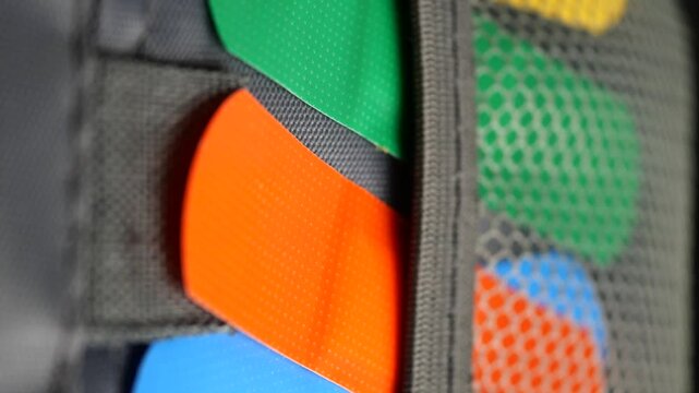 Colorful guitar picks in pocket changing colors dynamically in close up shot.