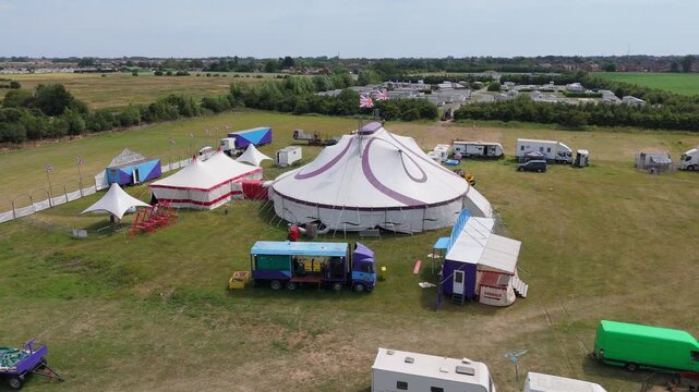 Aerial view of a large circus tent on open grass