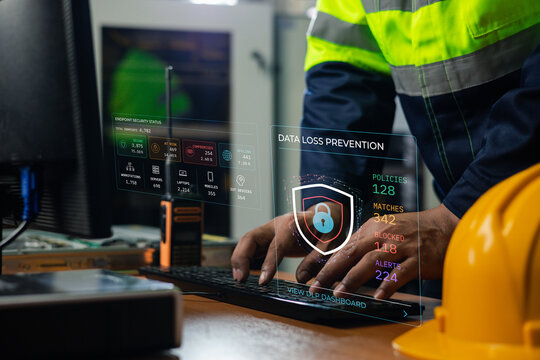 Industrial worker monitors data loss prevention and endpoint security on a digital dashboard. The scene represents data protection, policy enforcement, cyber defense,critical infrastructure security.