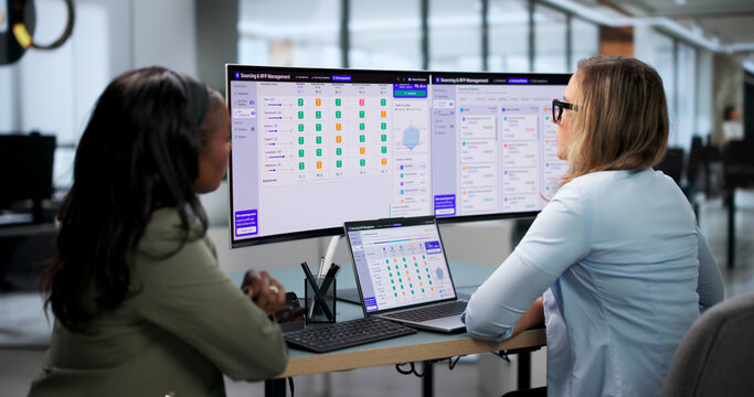 Procurement Manager And Assistant Review Supplier Bids Together