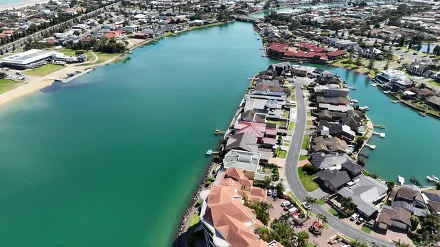 Aerial drone view over&nbsp;the peninsulas and winding waterways of West Lakes, Adelaide, South Australia, capturing luxury waterfront residential homes, private pontoon docks, curved suburban streets