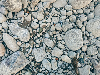Top view texture of grey river stones and smooth pebbles © VKirillov
