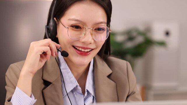 Asian Businesswoman with Headset Talking in Office Customer Service
