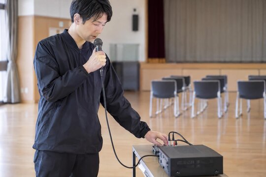 Technician checking a microphone before a community event