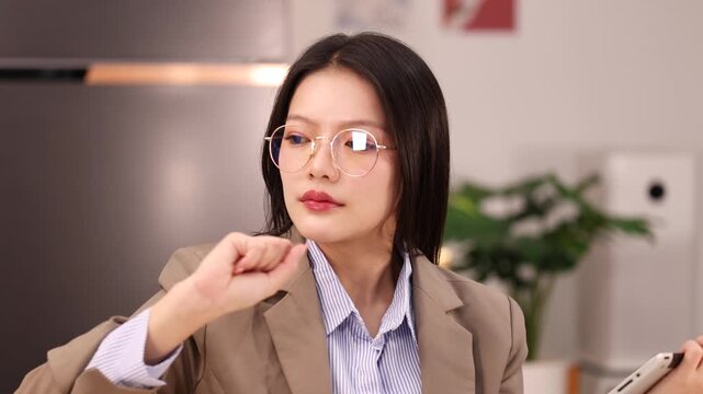 Asian Businesswoman Interacting With Virtual Screen Interface in Modern Office