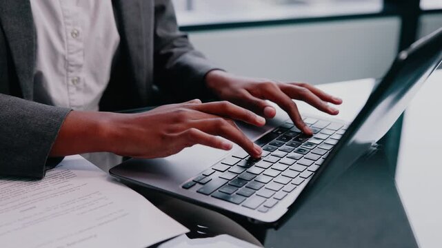 Laptop, person or hands typing in enterprise for insurance records, policy review or risk management. Office, computer keyboard and woman in corporate company, claims email or coverage summary