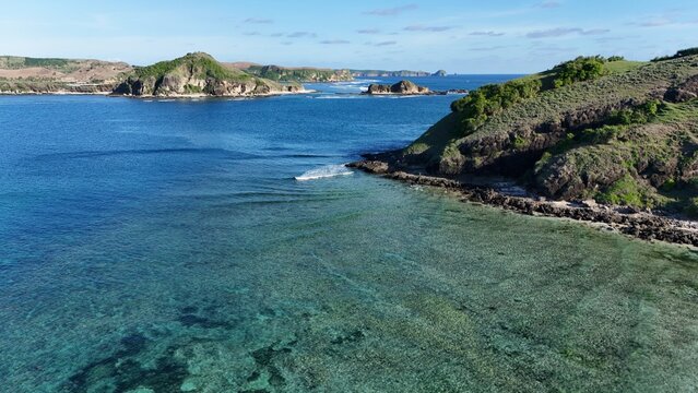 Aerial View of Turquoise Sea, Coral Reef and Coastal Hills near Bukit Merese in Central Lombok, Indonesia