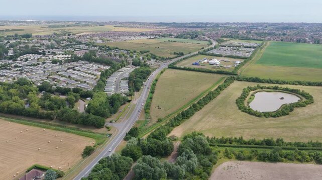 Aerial view shows roads splitting through suburban fields