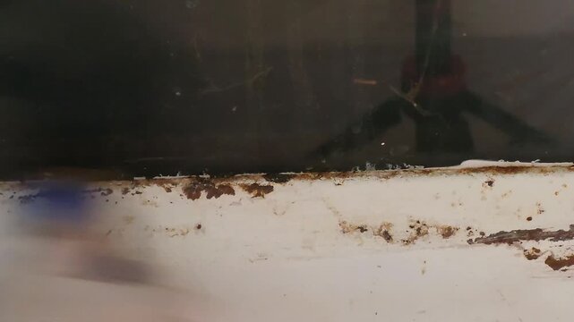 Sanding Rusted Edges Of Metal Stove Frame