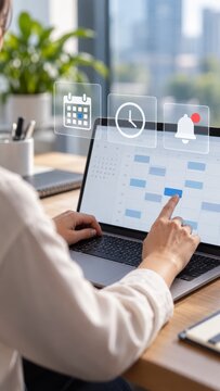 Person managing digital calendar schedule and time tasks on laptop computer interface display at modern office workplace desk.