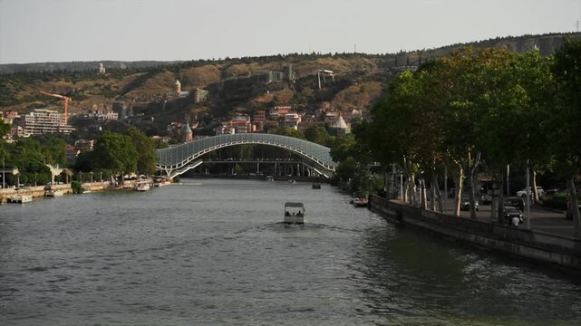 Tourist boat sails on Mtkvari River in Tbilisi Georgia