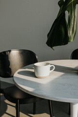 Fototapeta premium Minimalist scene with coffee mug in morning light