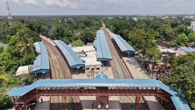 Aerial view of a train station in a lush green landscape