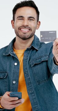 Phone, face and man in studio and show credit card for payment, ecommerce and bank account options. Portrait, white background and male with cellphone, debit info and subscription for online shopping