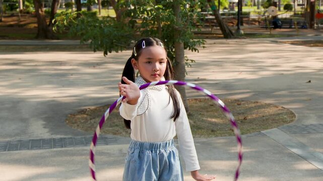Young Thai Girl Playing with Hula Hoop in Lumpini Park