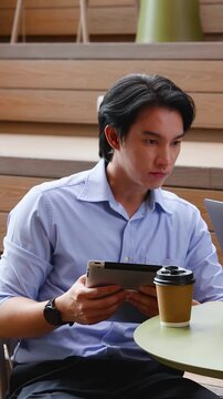 Asian Businessman Holding Digital Tablet During Office Meeting