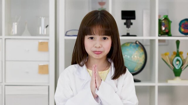 Young Girl in Science Lab Coat Greeting with Traditional Wai Gesture
