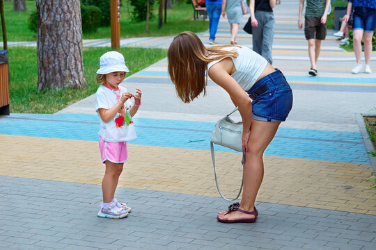 Young mother disciplines child by pointing out bad behavior