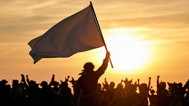 A person holds a white flag aloft amidst a cheering crowd at sunset.
