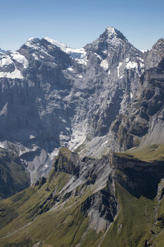 Swiss alpine peak with snow and green valleys