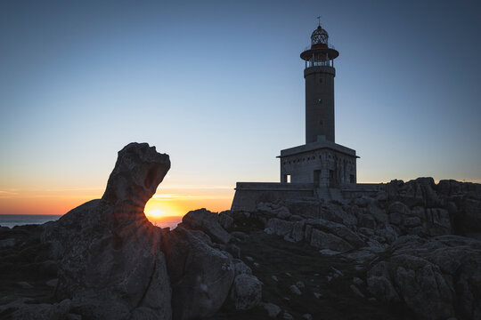 Punta Nariga lighthouse at sunset with unique rock formation
