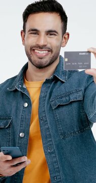 Credit card, show and face of man in studio for online shopping, payment and bank account options. Portrait, white background and happy person with phone, debit info and subscription for ecommerce