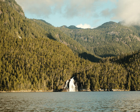 Green mountain valley with a waterfall in a fjord landscape