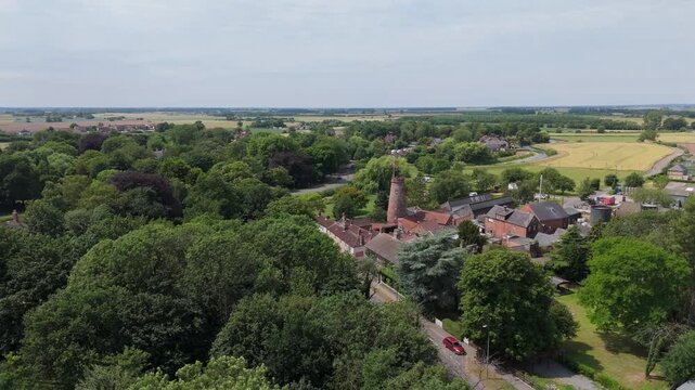 Aerial view of a quiet village nestled among green trees
