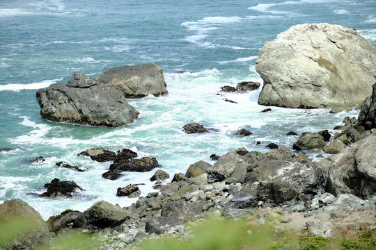 Waves crashing on a rocky coast with turquoise surf