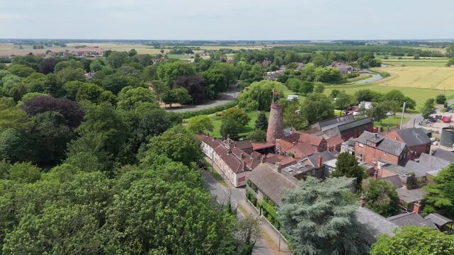 Aerial view of historic village nestled in green surroundings