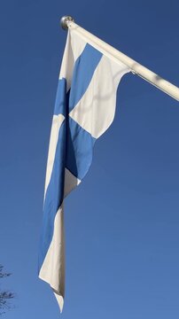 Finnish Flag Close Up Against Blue Sky Vertical Video