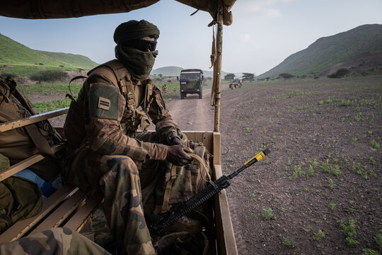 Military truck carrying a section along a desert track during French Army officer cadet training in Djibouti