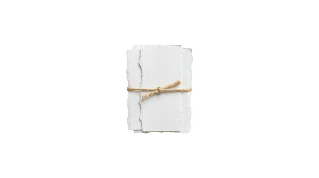 Stack of handmade paper sheets with deckled edges tied with a rustic twine string isolated on transparent background
