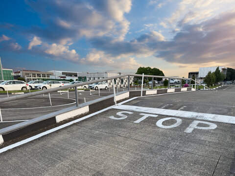 driver exam area with a stop sign and cars under a cloudy sky in the late afternoon at a commercial location
