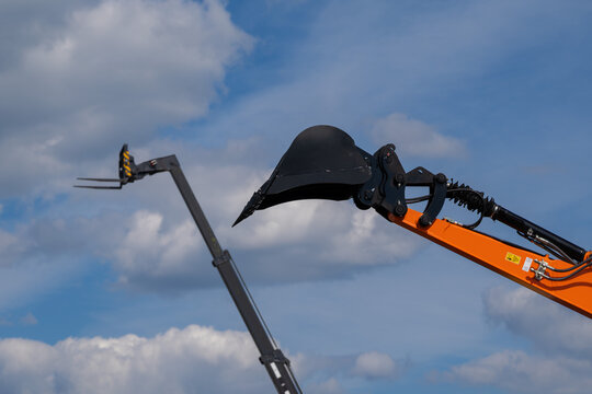 Construction machinery, high-rise and lifting equipment against a blue sky