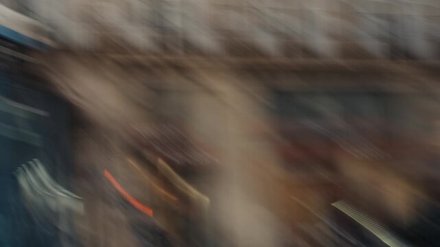 Blurry people walking in a busy city street of paris