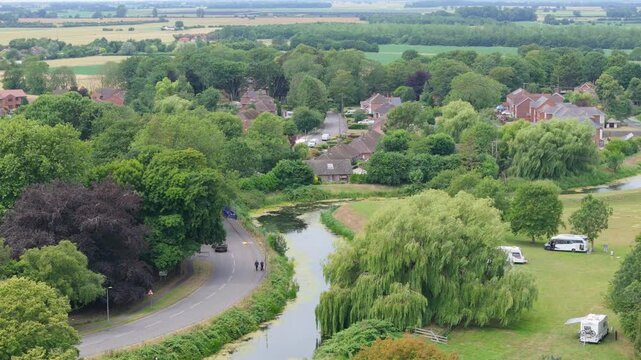 Aerial view of quiet village beside calm waterway