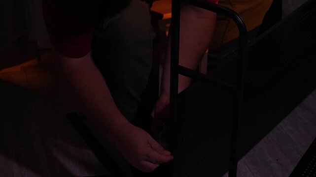 a man assembles a metal cabinet