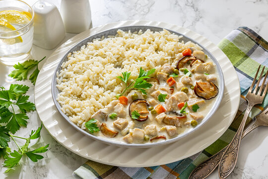 Chicken stew with wild mushrooms, rice on plate