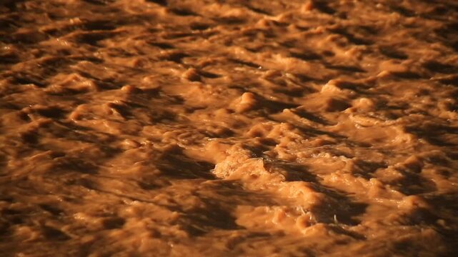 The river water flows murky due to the strong current