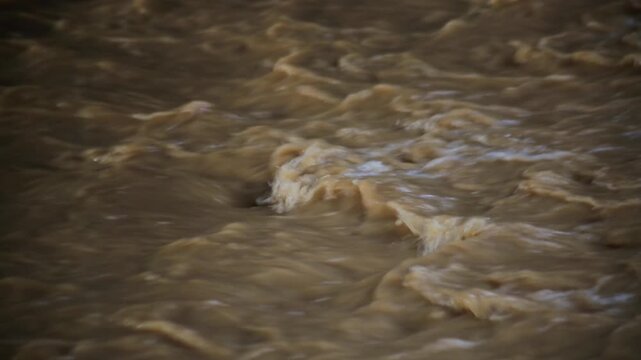 The river water flows murky due to the strong current
