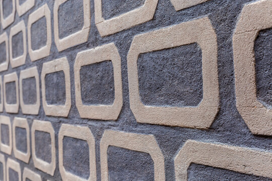 Wall part with gray geometric pattern made with sgraffito technique