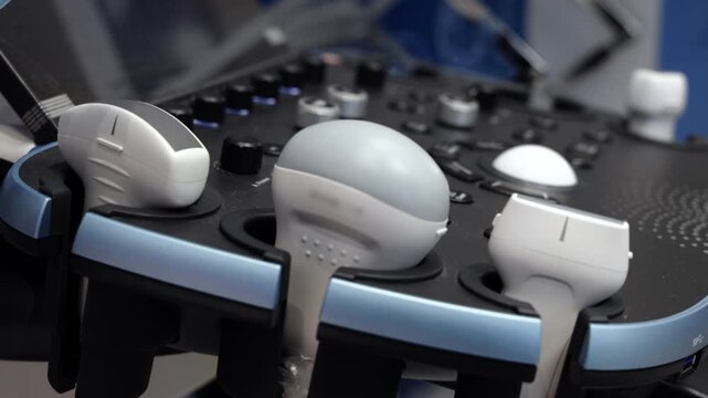 Multiple ultrasound probes connected to a modern diagnostic console with control panel.