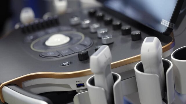Ultrasound probes arranged beside the control panel of a modern medical ultrasound machine.