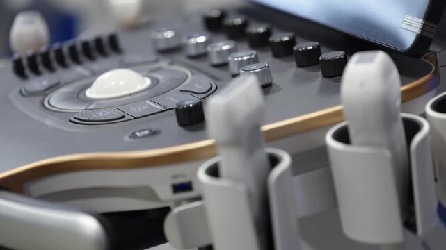 Professional ultrasound probes mounted on a diagnostic system beside the control panel.