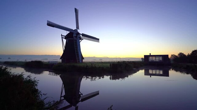 A traditional windmill during a tranquil, autumn dawn in the Dutch countryside. Krimstermolen, Zuidwolde.