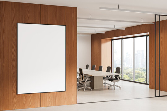 Contemporary corporate office interior with blank poster mockup on wood wall, conference table, glass meeting room, and city view. 3D Rendering