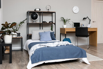 Remote learning and student lifestyle, modern bedroom interior with study desk and bed for teenager or young adult in a minimalist apartment home © Pixel-Shot