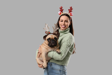 Christmas holiday celebration, happy woman with french bulldog wearing reindeer antlers for festive winter season party and family greeting card © Pixel-Shot